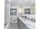 Stylish bathroom with double vanity, marble countertop, and a decorative tile floor at 2401 Wensley Dr, Charlotte, NC 28210