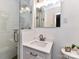 Modern bathroom featuring a tiled shower with glass door and a sleek vanity with white countertop at 2401 Wensley Dr, Charlotte, NC 28210