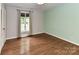Bedroom featuring hardwood floors, neutral walls, and a window with curtains for natural light at 2401 Wensley Dr, Charlotte, NC 28210