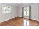 Bedroom featuring hardwood floors, neutral walls, and two windows with curtains for natural light at 2401 Wensley Dr, Charlotte, NC 28210