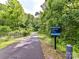 Little Sugar Creek Greenway access path at 2355 Tanbark Place, framed by green trees and a chain link fence at 2401 Wensley Dr, Charlotte, NC 28210