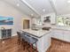 Modern kitchen with white cabinets, granite countertops, and an island with seating for three at 2401 Wensley Dr, Charlotte, NC 28210