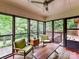 Bright sunroom with large windows overlooking greenery, and cozy seating area with stylish chairs at 2401 Wensley Dr, Charlotte, NC 28210