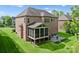 Stunning backyard showcasing a screened porch and brick patio, perfect for outdoor living at 2606 Walker Rd, Matthews, NC 28105