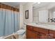 Bathroom featuring granite counters, a shower, and an enclosed toilet area at 2606 Walker Rd, Matthews, NC 28105