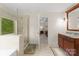 Spa-like bathroom features a glass shower, soaking tub, and granite vanity offering a luxurious and relaxing experience at 2606 Walker Rd, Matthews, NC 28105