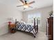 Charming bedroom featuring a large window, ceiling fan, and hardwood flooring at 2606 Walker Rd, Matthews, NC 28105