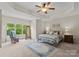 Serene bedroom with tray ceiling, large windows, and plush carpet offers a peaceful retreat for rest and relaxation at 2606 Walker Rd, Matthews, NC 28105