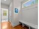 Inviting hallway with bench seating and storage hooks offers a practical and organized transition space with natural light at 2606 Walker Rd, Matthews, NC 28105