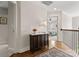 Hallway with hardwood floors, decorative cabinet, and view into the bedroom at 2606 Walker Rd, Matthews, NC 28105