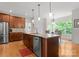 Bright kitchen features stainless appliances, granite island, breakfast nook, and wood flooring offering style and functionality at 2606 Walker Rd, Matthews, NC 28105