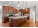 Well-appointed kitchen features a center island, granite countertops, stainless steel appliances, and wood cabinetry at 2606 Walker Rd, Matthews, NC 28105