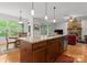 Open kitchen with granite countertops, island, and breakfast area with abundant natural light, perfect for modern living at 2606 Walker Rd, Matthews, NC 28105