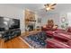 Comfortable living room with a stone fireplace, hardwood floors, and plenty of natural light at 2606 Walker Rd, Matthews, NC 28105