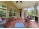 Relaxing screened-in porch with comfortable seating area and natural brick at 2606 Walker Rd, Matthews, NC 28105