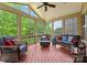 Relaxing sunroom with comfortable seating, ceiling fan, and large windows overlooking the backyard at 2606 Walker Rd, Matthews, NC 28105