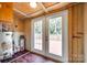 View of the back room with doors to the deck, water heater, and storage shelves at 275 N Garrison Rd, Rock Hill, SC 29730