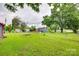 Large backyard with various sheds, a dog house, and a covered deck at 275 N Garrison Rd, Rock Hill, SC 29730