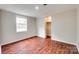 A bright bedroom features hardwood floors and white trim and paneling at 275 N Garrison Rd, Rock Hill, SC 29730
