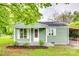 Charming home featuring a quaint front porch, complemented by manicured landscaping at 275 N Garrison Rd, Rock Hill, SC 29730