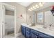 Charming bathroom with dual vanity, bathtub, and stylish blue cabinetry at 3115 Duck Point Dr, Monroe, NC 28110