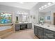 Spa-like bathroom with dual vanity, soaking tub, and abundant natural light at 3115 Duck Point Dr, Monroe, NC 28110