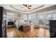 Spacious primary bedroom with hardwood floors, tray ceiling, and natural light at 3115 Duck Point Dr, Monroe, NC 28110