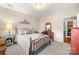 Inviting bedroom with neutral decor, a comfortable bed, and a charming accent wall at 3115 Duck Point Dr, Monroe, NC 28110