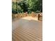 Spacious deck with a beautiful, decorative railing and lush, green trees in the background at 3115 Duck Point Dr, Monroe, NC 28110