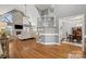 Open-concept living room with high ceilings, fireplace, hardwood floors, dining room and staircase at 3115 Duck Point Dr, Monroe, NC 28110