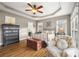 Comfortable main bedroom with hardwood floors, neutral colors, and a decorative ceiling fan at 3115 Duck Point Dr, Monroe, NC 28110