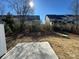 Backyard with a concrete slab, view of the rear of neighboring homes and underbrush at 4131 Black Ct # 170, Harrisburg, NC 28075