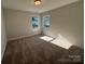 Neutral bedroom featuring carpet floors and dual windows, ready for personalization and comfort at 4131 Black Ct # 170, Harrisburg, NC 28075