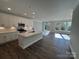 Open-concept kitchen featuring white cabinets, an island with a sink, and stainless steel appliances at 4131 Black Ct # 170, Harrisburg, NC 28075