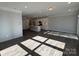 Open-concept living area with dark hardwood floors and a kitchen in the background at 4131 Black Ct # 170, Harrisburg, NC 28075