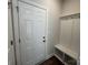 Mudroom features a white door and a built-in bench with storage hooks for coats and bags at 4131 Black Ct # 170, Harrisburg, NC 28075