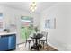 Cozy dining area with white brick walls, a modern light fixture, and a view to the backyard at 4226 Randolph Rd, Charlotte, NC 28211