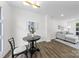 Bright dining room with updated brick walls, wood floors, and contemporary lighting at 4226 Randolph Rd, Charlotte, NC 28211