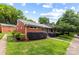 Charming brick house with well-maintained landscaping, green lawn, and inviting curb appeal at 4226 Randolph Rd, Charlotte, NC 28211