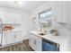 Modern kitchen with white cabinets, quartz countertops, and updated stainless steel appliances at 4226 Randolph Rd, Charlotte, NC 28211