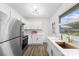 Stylish kitchen featuring white cabinets, modern appliances, and a bright window with a view to the outdoors at 4226 Randolph Rd, Charlotte, NC 28211