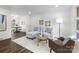 Bright living room with white brick walls, wood floors, and a comfortable seating arrangement at 4226 Randolph Rd, Charlotte, NC 28211