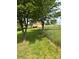 Expansive backyard with lush greenery, a covered carport, and a partial view of the home at 443 Troutman Farm Rd, Statesville, NC 28677