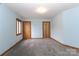 Light blue bedroom features neutral carpet, a window, and two wooden doors at 443 Troutman Farm Rd, Statesville, NC 28677