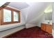 Bonus room featuring red carpet, sink with wood cabinets, window and sloped ceiling at 443 Troutman Farm Rd, Statesville, NC 28677