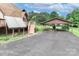Covered carport, next to the home, features a large paved area and plenty of space for parking at 443 Troutman Farm Rd, Statesville, NC 28677