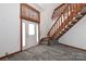 Inviting entryway with plush gray carpet, a bright white door, and a wooden staircase at 443 Troutman Farm Rd, Statesville, NC 28677