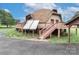 Unique dome home featuring a large deck, with wood stairs, complemented by energy-efficient solar panels at 443 Troutman Farm Rd, Statesville, NC 28677