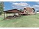 Spacious yard with carport and dome-shaped house with deck, situated on a well-maintained lawn at 443 Troutman Farm Rd, Statesville, NC 28677