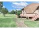 View of the home and deck, complemented by a stone pathway at 443 Troutman Farm Rd, Statesville, NC 28677